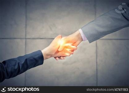 We are partners. Top view of two businesswpeople shaking hands