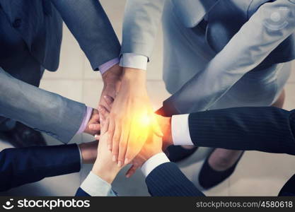 We are team. Close up of many business people hands lying on each other
