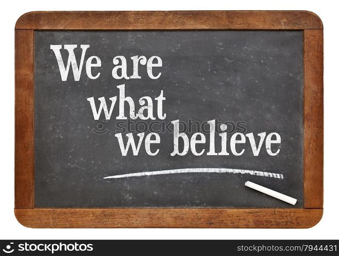 We are what we believe - text on a vintage slate blackboard