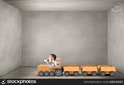 We deliver fast. Funny image of businessman riding in carton train