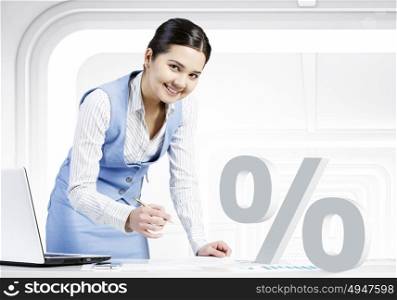 We offer best interest rates. Young businesswoman working at table in her office