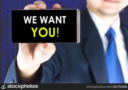 We want you word on mobile phone screen in blurred young businessman hand and digital technology background