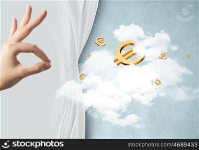 Wealth concept. Close up of hand opening white curtain with euro sign behind it