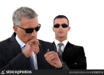 Wealthy businessman smoking cigar