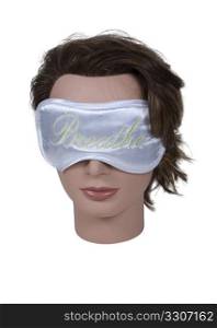 Wearing a sleep mask designed to keep the light out while taking a snooze