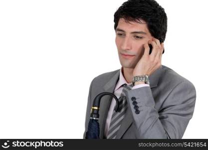 Weary businessman talking on his mobile phone