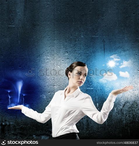 Weather balance. Image of businesswoman holding items on palms