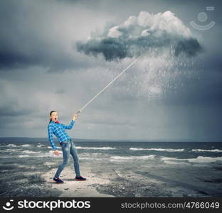 Weather concept. Young woman in casual holding cloud on lead