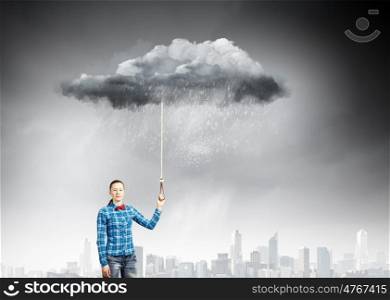 Weather concept. Young woman in casual holding cloud on lead