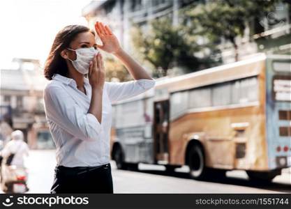 Weather, Pollution and Ecology Issue Concept. Young Woman Wearing Protection Mask against Roadside in the City