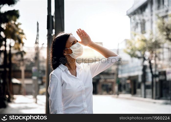 Weather, Pollution and Ecology Issue Concept. Young Woman Wearing Protection Mask against Roadside in the City