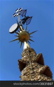 Weather vane on the roof of Gaudi&rsquo;s Neo-Gothic palace of Palau Guell, just off Las Rambla in the Eixample district of Barcelona in the Catalonia region of Spain.