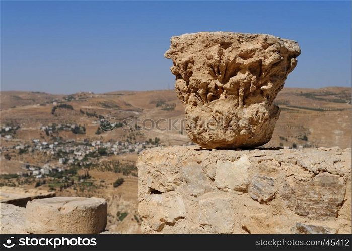 Weathered column capital on the ruins of medieval Kerak castle in Jordan