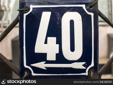 Weathered grunge square metal enamelled plate of number of street address with number 40 closeup
