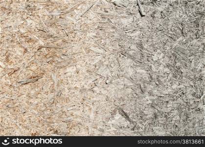 Weathered oriented strand board surface closeup as background