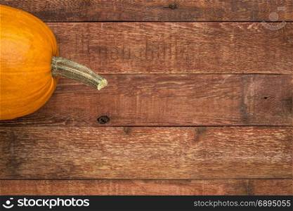 weathered plank barn wood background with a pumpkin
