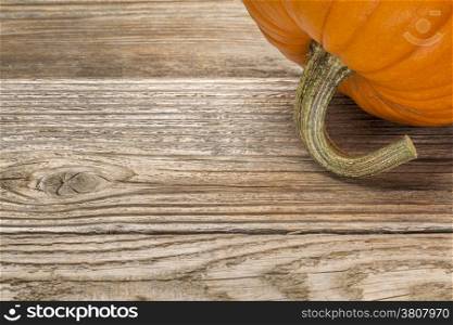 weathered plank wood background with a pumpkin