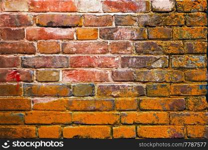 Weathered red and brown stained old brick wall background, copyspace. Weathered red and brown stained old brick wall background