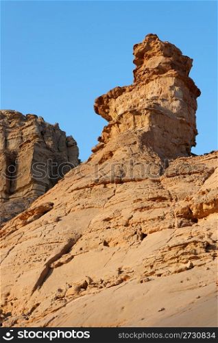 Weathered rock finger in stone desert