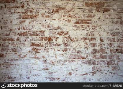 Weathered stained red brick wall background texture peeling plaster retro. Weathered stained red brick wall background texture peeling plaster