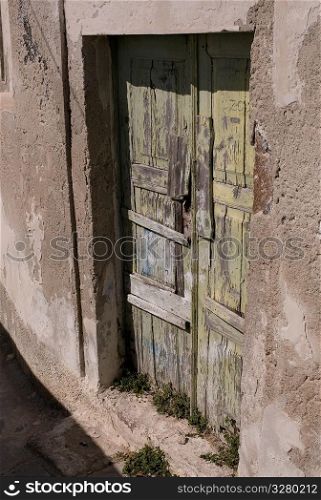 Weathered wooden doors in Santorini Greece