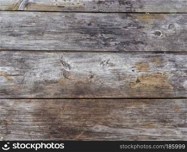 Weathered worn natural unpainted timber fence. Natural texture of old unpainted boards. Old unpainted boards.