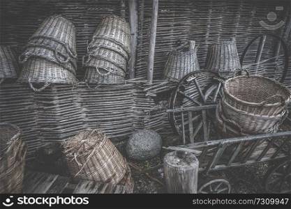 Weave baskets workshop stacked in a wooden cabin with old wheels and ladders