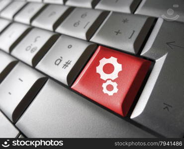 Web account, technology support and website settings concept with two gears icon and symbol on a red laptop computer key for Internet and online business.