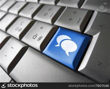 Web and social media concept with speech clouds icon and symbol on a blue laptop computer key for Internet and online business.