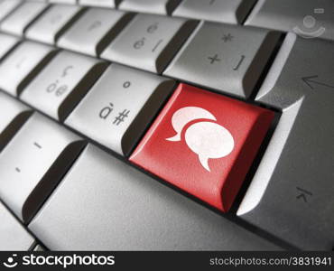 Web and social network concept with speech clouds icon and symbol on a red laptop computer key for Internet and online business.