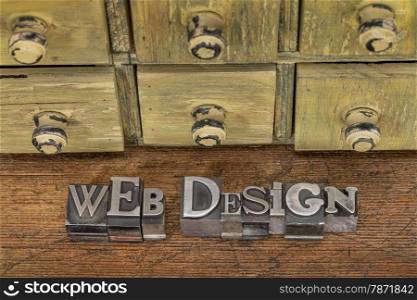 web design - text in vintage letterpress metal type blocks on a grunge wood with rustic drawer cabinet in background