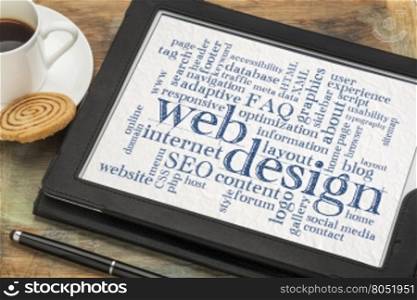 web or website design concept - a word cloud on a digital tablet with a cup of coffee
