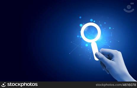 Web searching. Close up of male hand holding digital icon