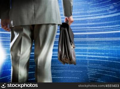 Web site creation. Rear view of businessman with suitcase and digital background