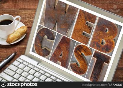 webcast word in vintage letterpress wood type printing blocks on laptop screen with cup of coffee