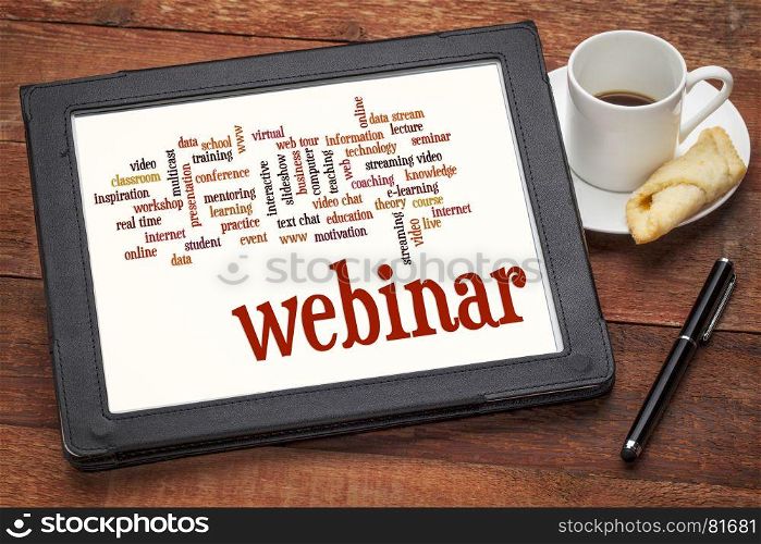 webinar (web seminar) and online education word cloud on a digital tablet with cup of coffee