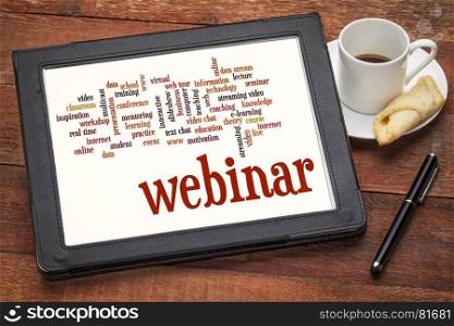 webinar (web seminar) and online education word cloud on a digital tablet with cup of coffee