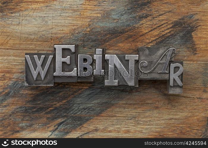 webinar word in vintage letterpress metal type on a grunge painted wood background