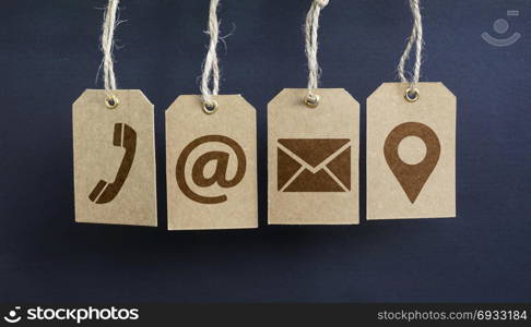Website contact us icons on hanged paper tags with email, at, telephone and location pin symbol.