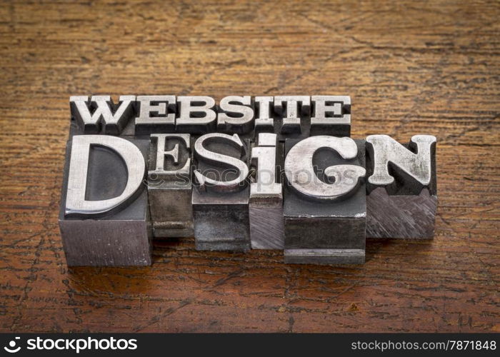 website design text in mixed vintage metal type printing blocks over grunge wood