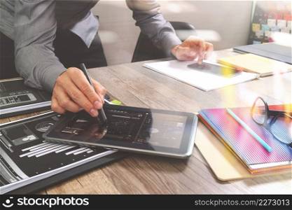 Website designer holding smart phone and working computer digital tablet on wood table,filter effect 