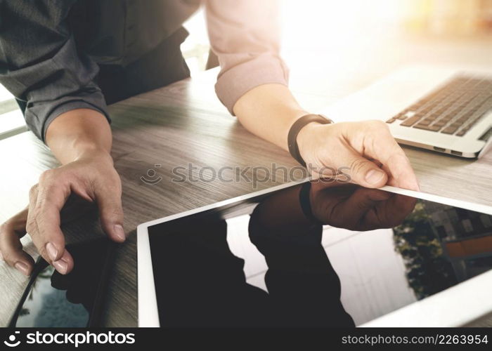 Website designer working blank screen digital tablet and computer laptop with smart phone on wooden desk as concept