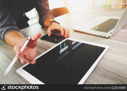 Website designer working blank screen digital tablet and computer laptop with smart phone on wooden desk as concept