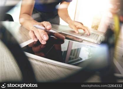 Website designer working blank screen digital tablet and computer laptop with smart phone on wooden desk as concept