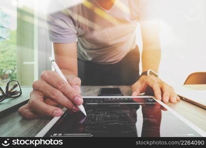 Website designer working digital tablet and computer laptop and digital design diagram on wooden desk as concept