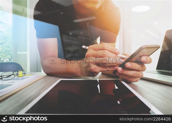 Website designer working digital tablet and computer laptop and digital design diagram on wooden desk as concept