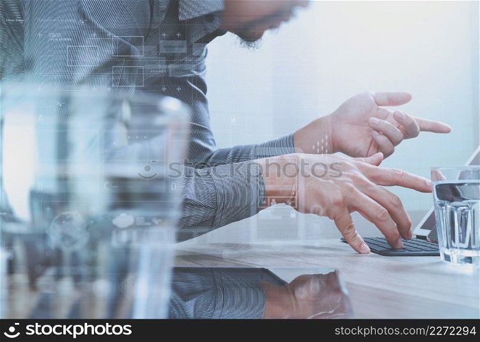 Website designer working digital tablet and computer laptop with digital tablet and digital design diagram on wooden desk,digital screen graphic virtual icons,graph,diagram 