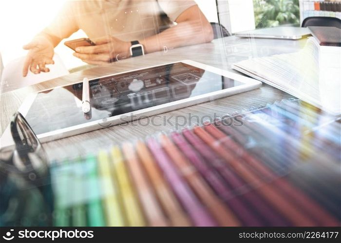 Website designer working digital tablet and computer laptop with smart phone and digital design diagram on wooden desk as concept
