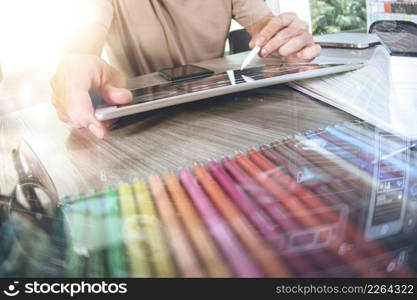 Website designer working digital tablet and computer laptop with smart phone and digital design diagram on wooden desk as concept