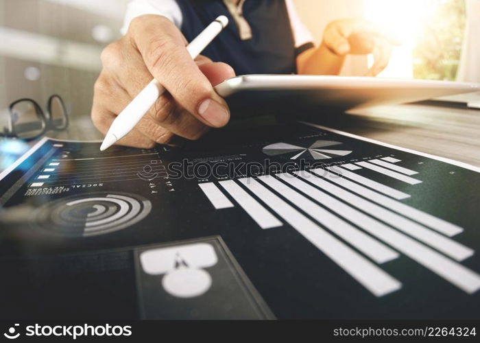 Website designer working digital tablet and computer laptop with smart phone and digital design diagram on wooden desk as concept